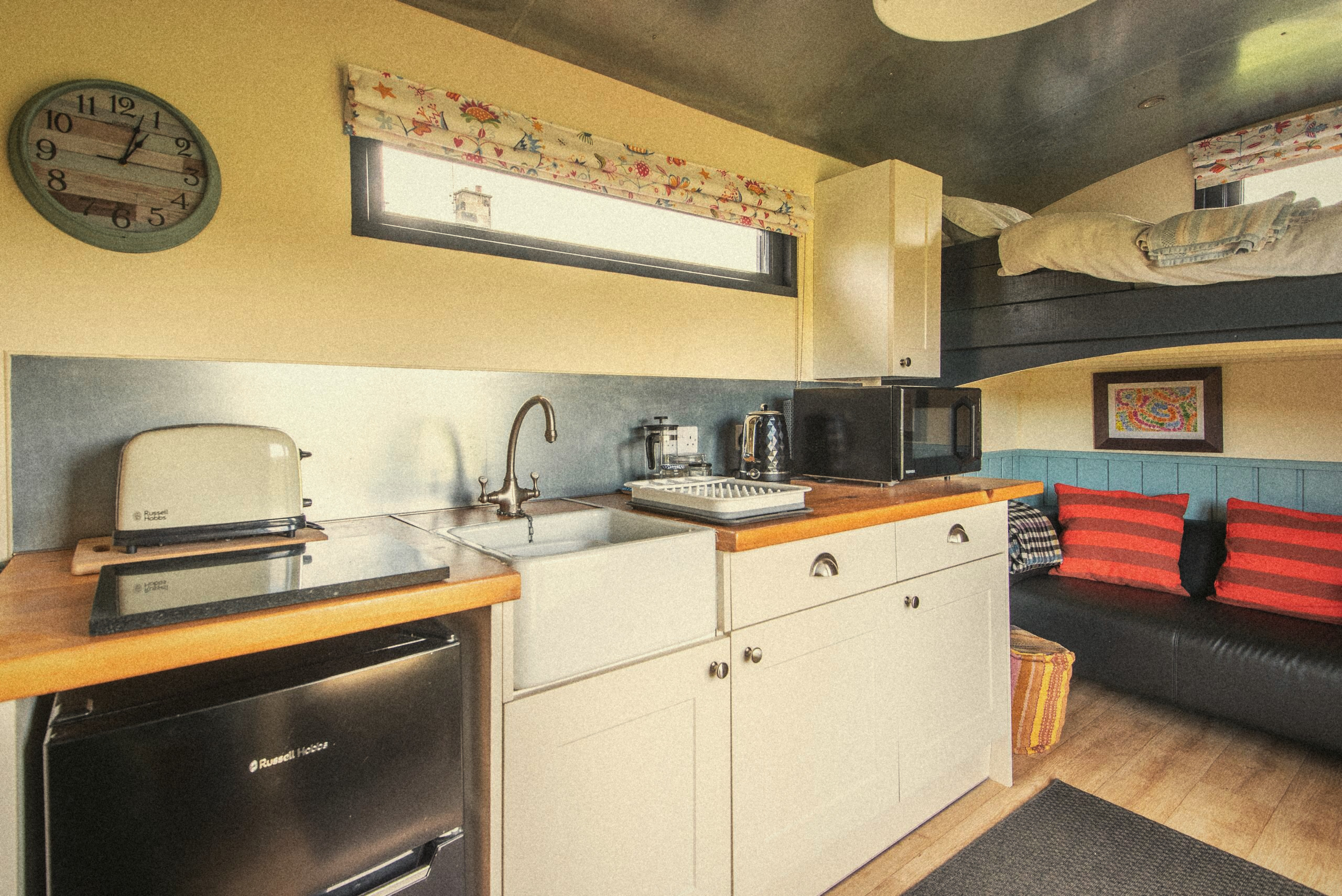 The kitchen sink, fridge and cooking area