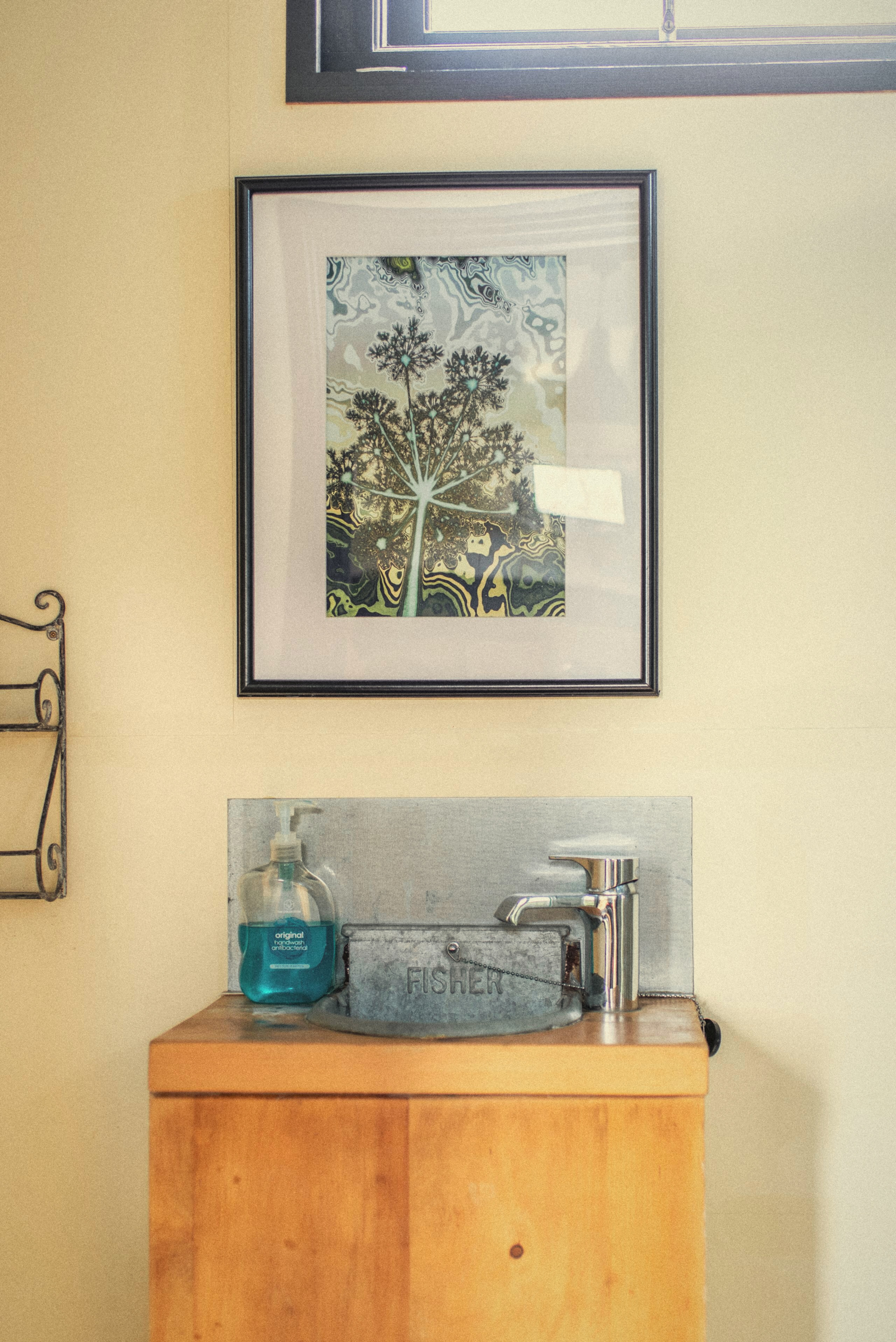 A framed picture and cupboard inside The Carriage