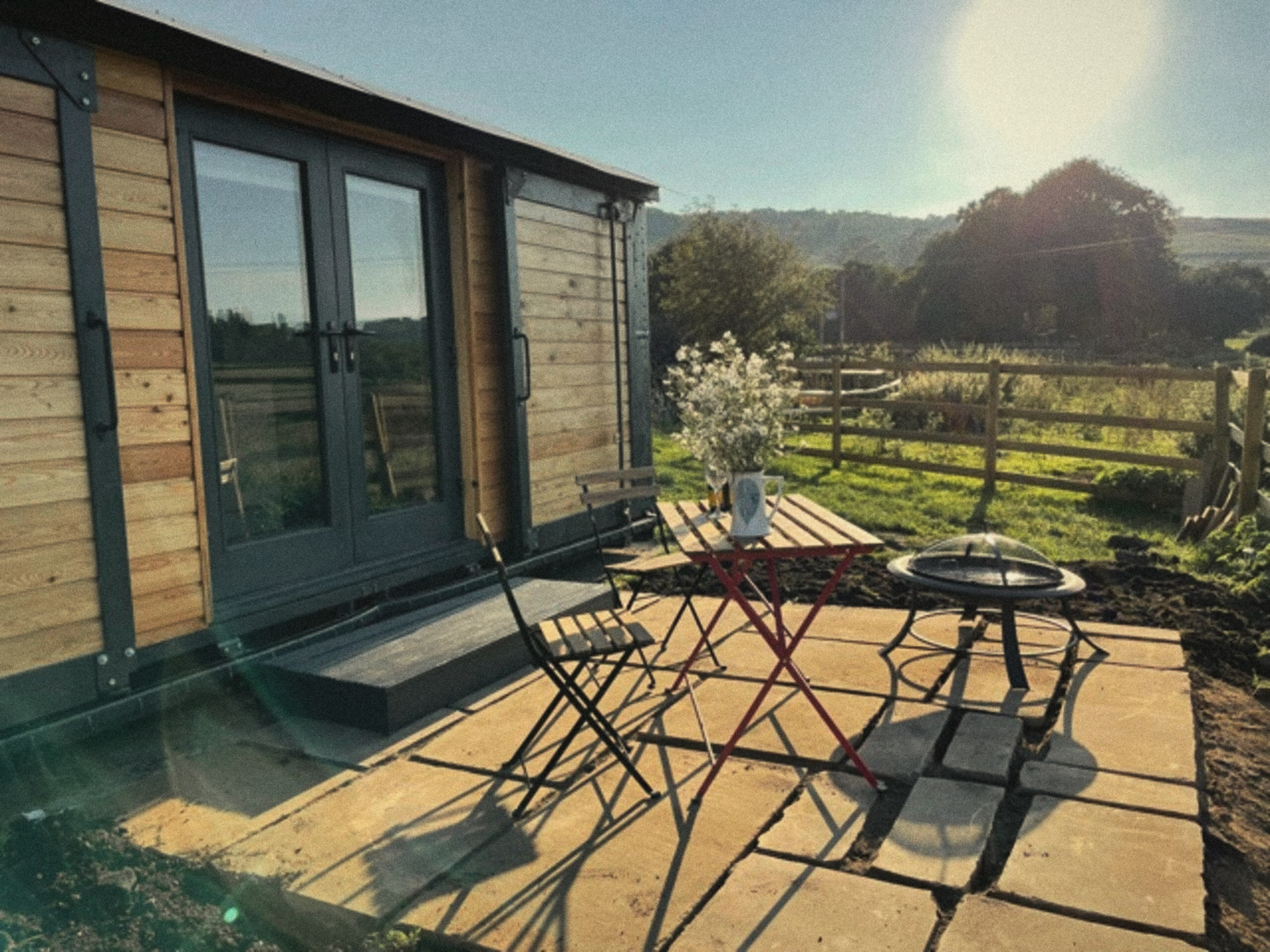 The Carriage patio with table and chairs beside the doors