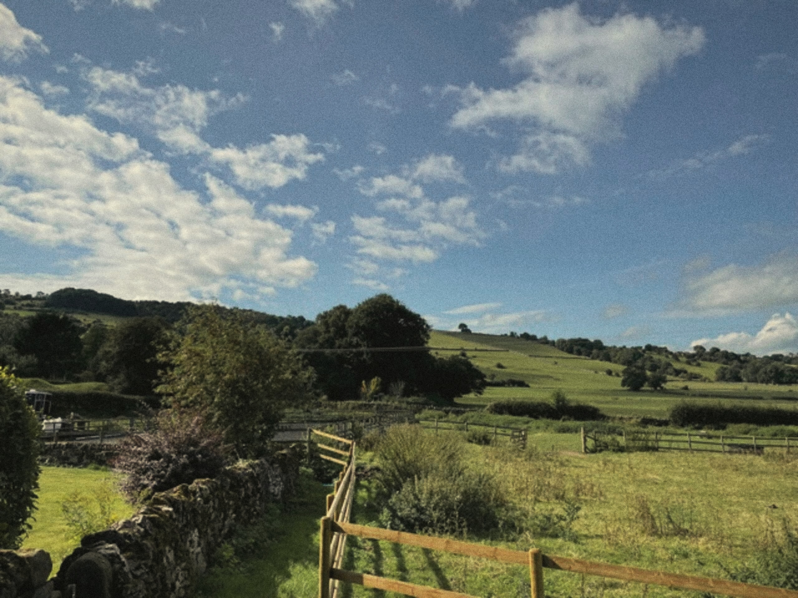 The fence and countryside beyond The Carriage