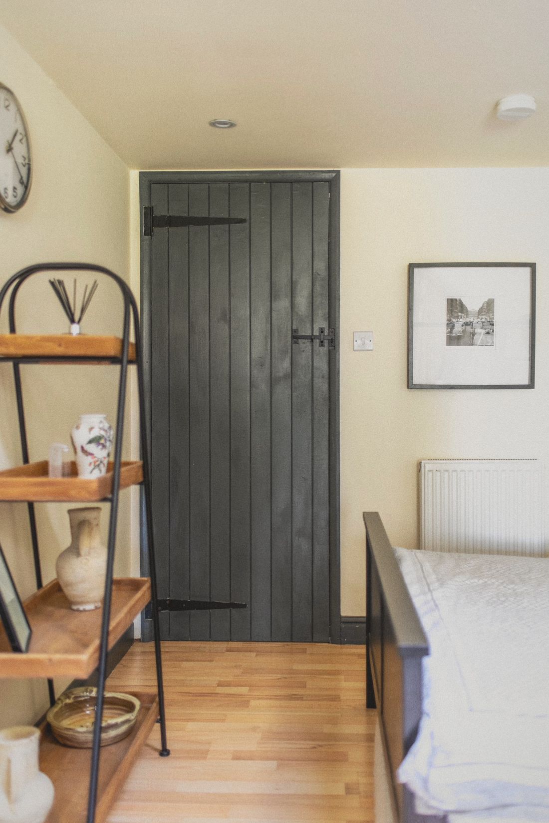 The grey plank door and shelf inside The Forge
