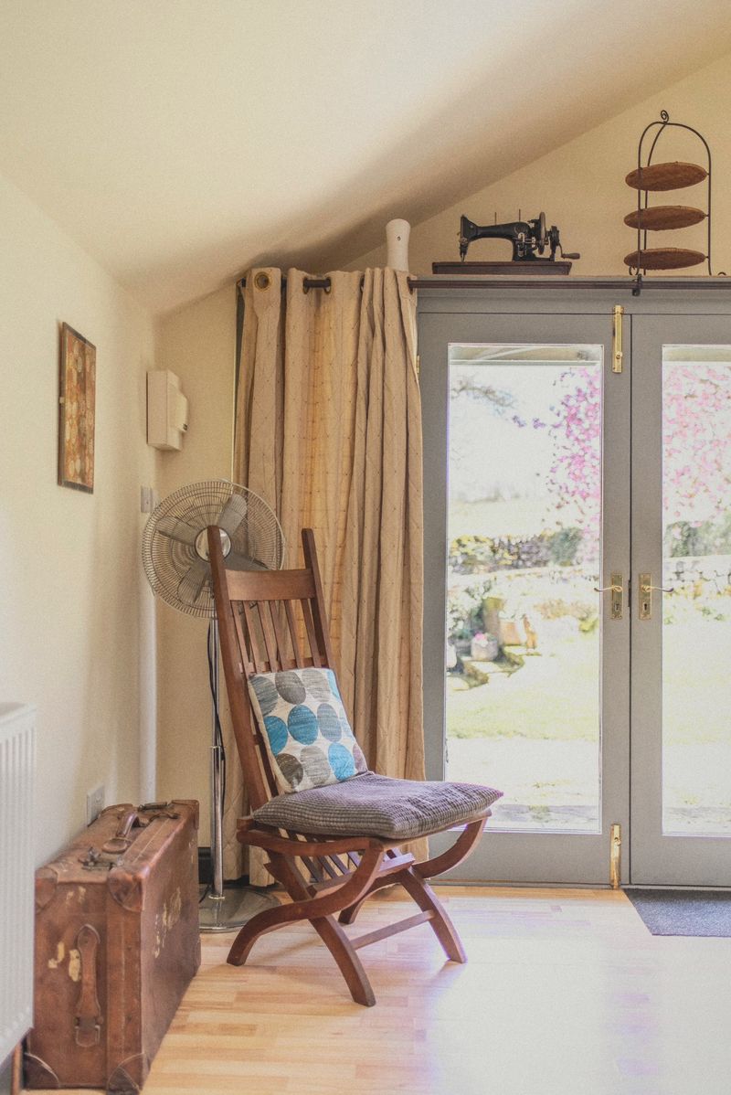 The patio doors with a folding chair and wooden trunk