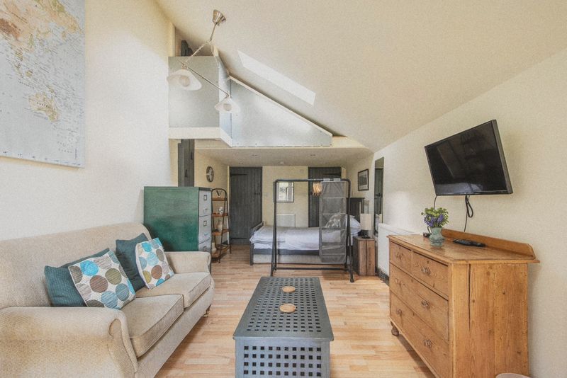 The open-plan studio from the sitting area to the bed