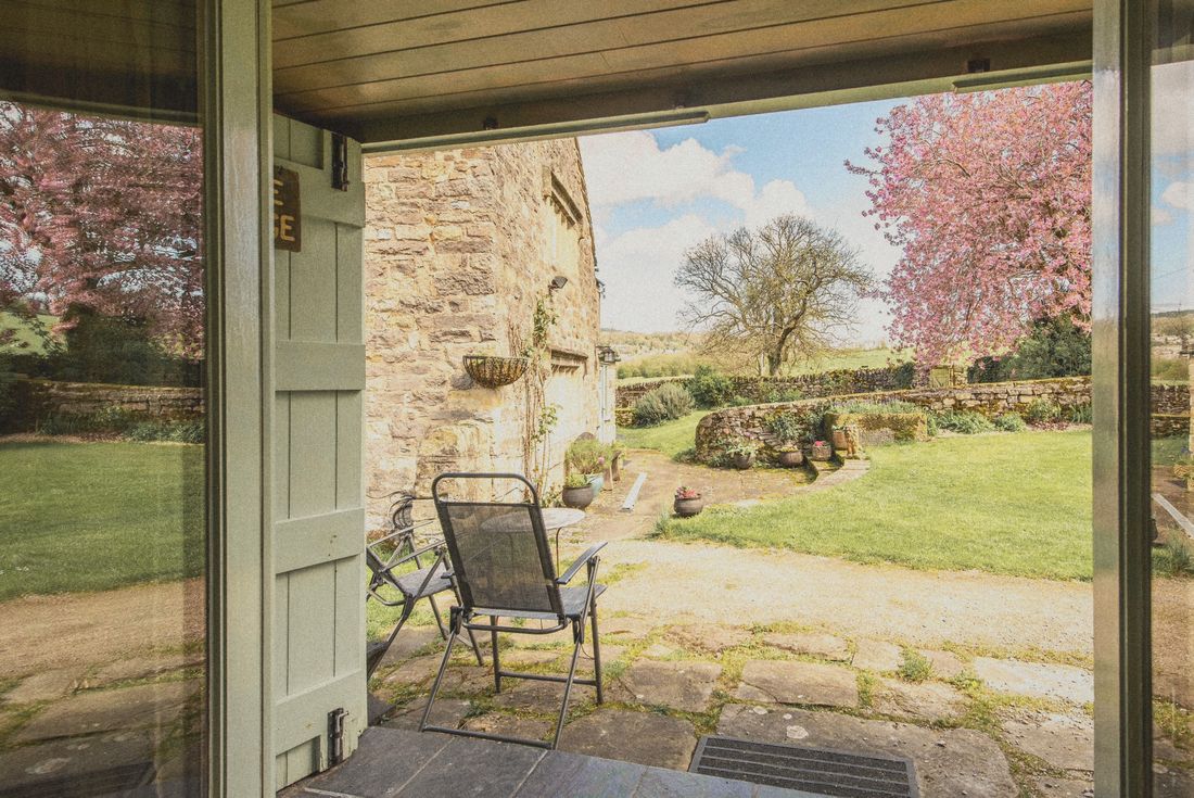 The view from The Forge’s open doors to the patio and blossom tree