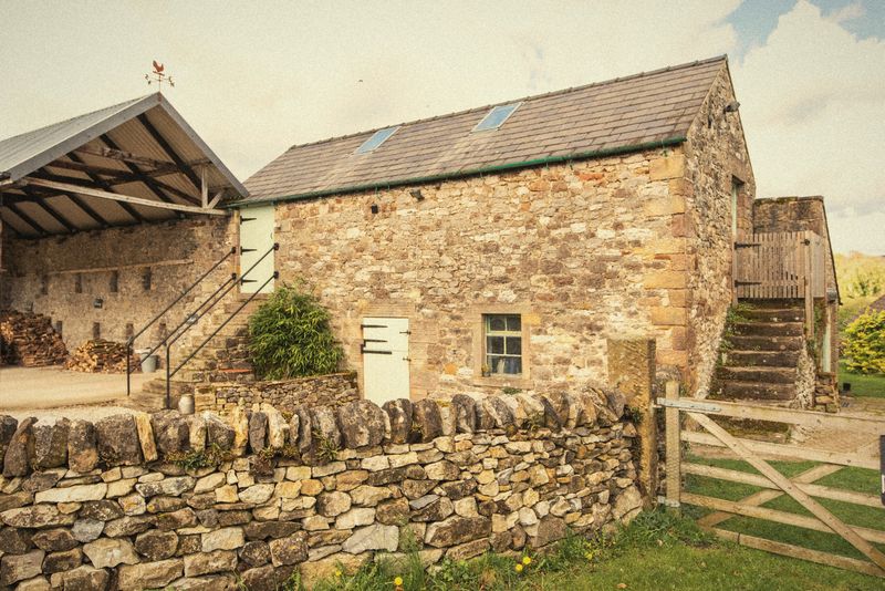 The Hayloft barn, its stone steps and the field gate