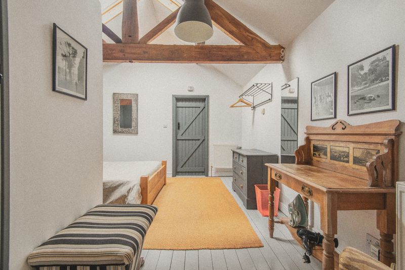 The bedroom with dressing table and orange rug