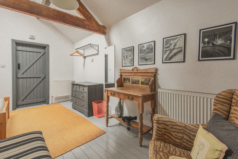 The bedroom with wicker chair and rug