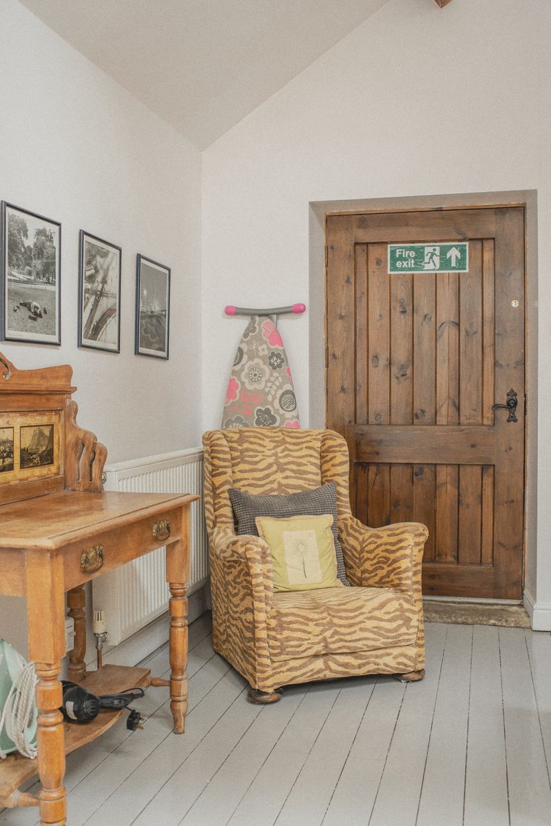 A reading corner with armchair and plank door
