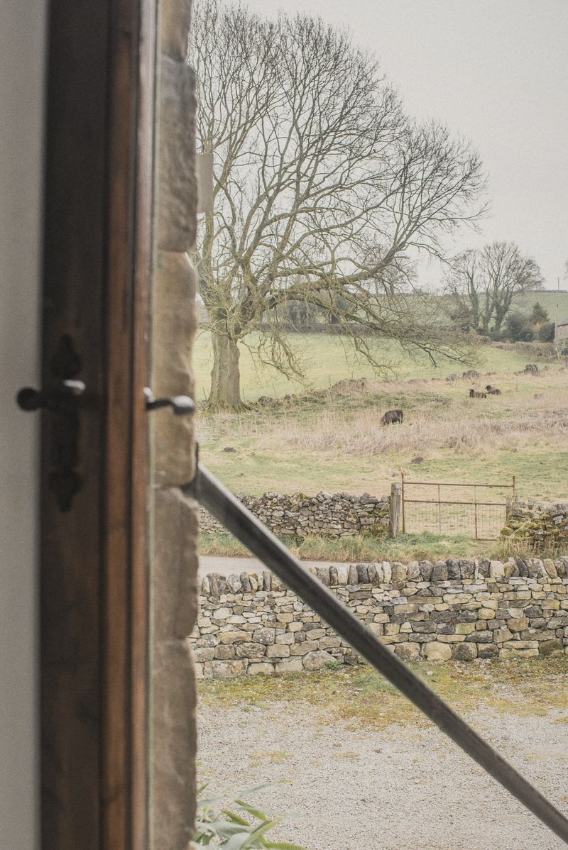 The view through The Hayloft doorway across the stone walls and fields