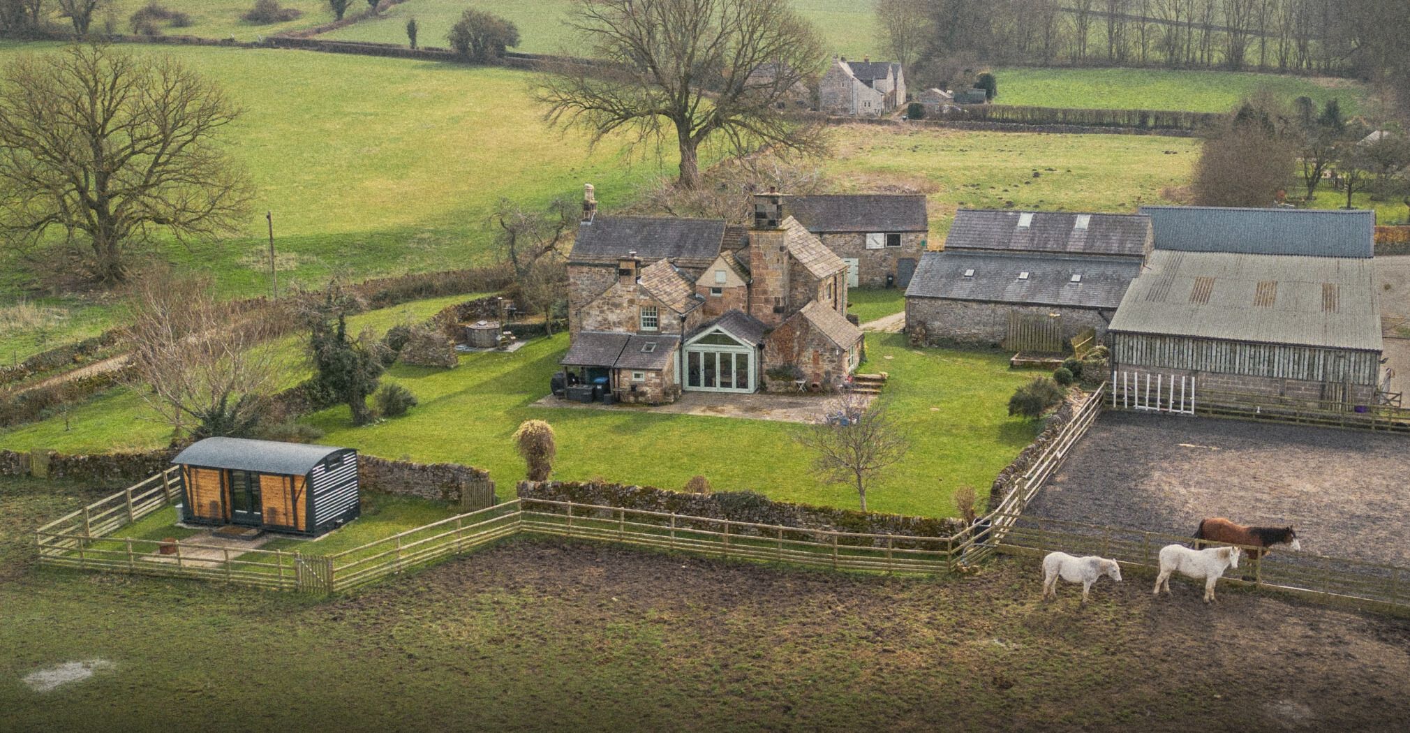 The Old Manor House from the air, with its garden, The Carriage and horses in the paddock