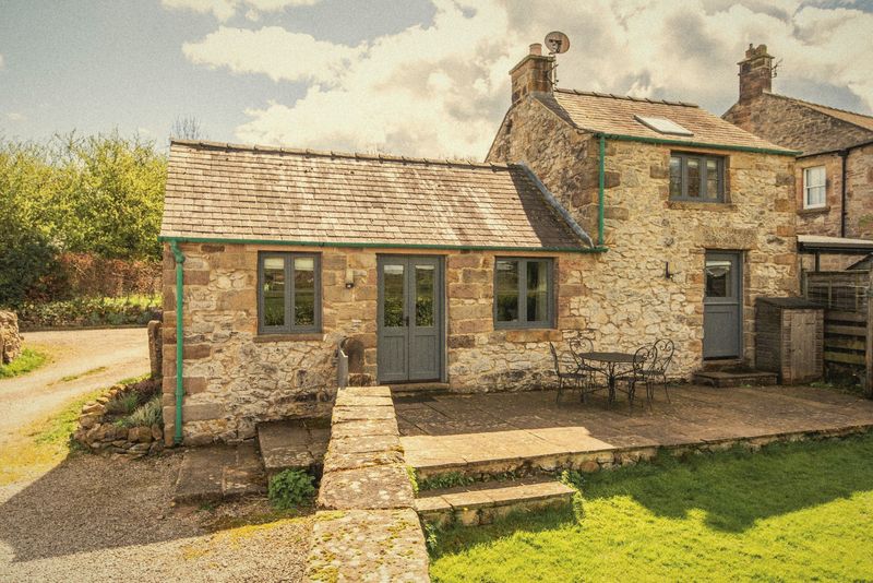 The cottage and its walled garden beside the yard