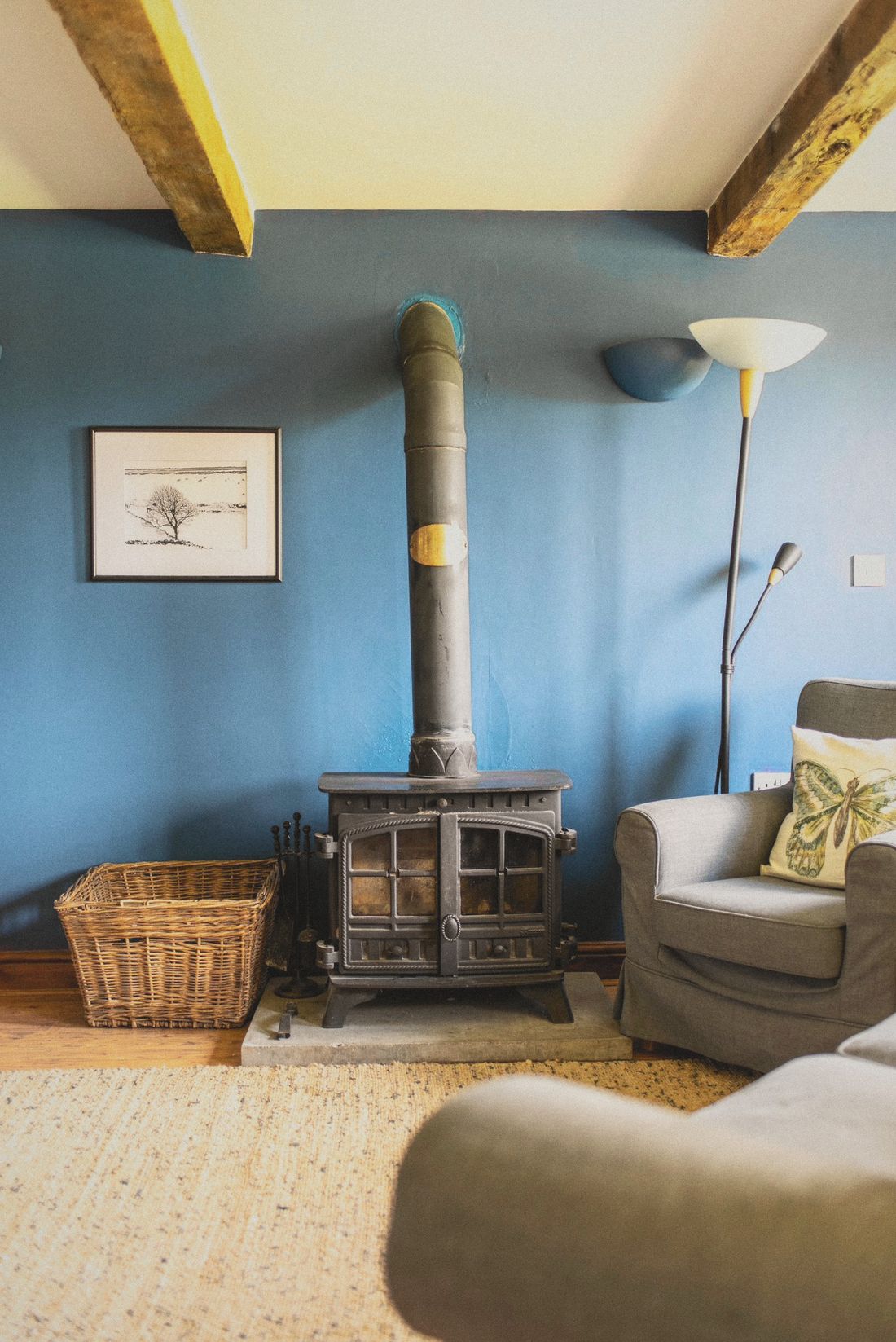 The log-burning stove in the beamed sitting room at Thistledown Cottage